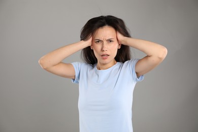 Photo of Portrait of shocked woman on grey background