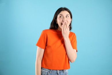 Photo of Portrait of surprised woman on light blue background