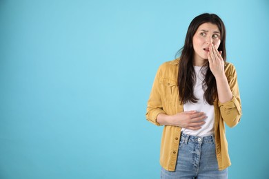 Photo of Portrait of shocked woman on light blue background, space for text