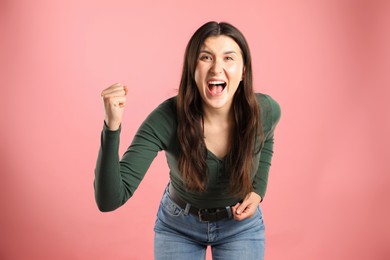Photo of Portrait of emotional woman on pink background