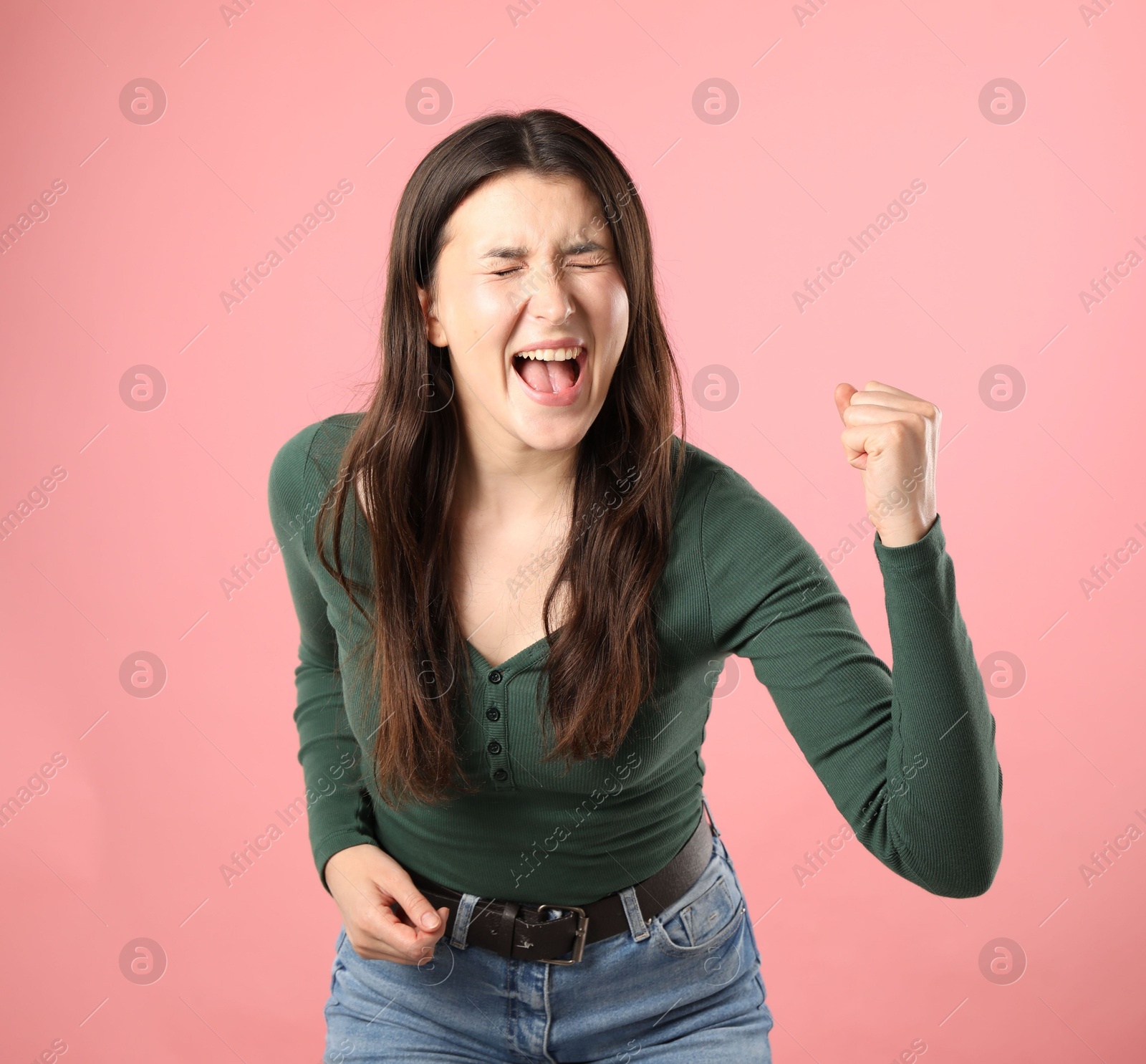 Photo of Portrait of emotional woman on pink background