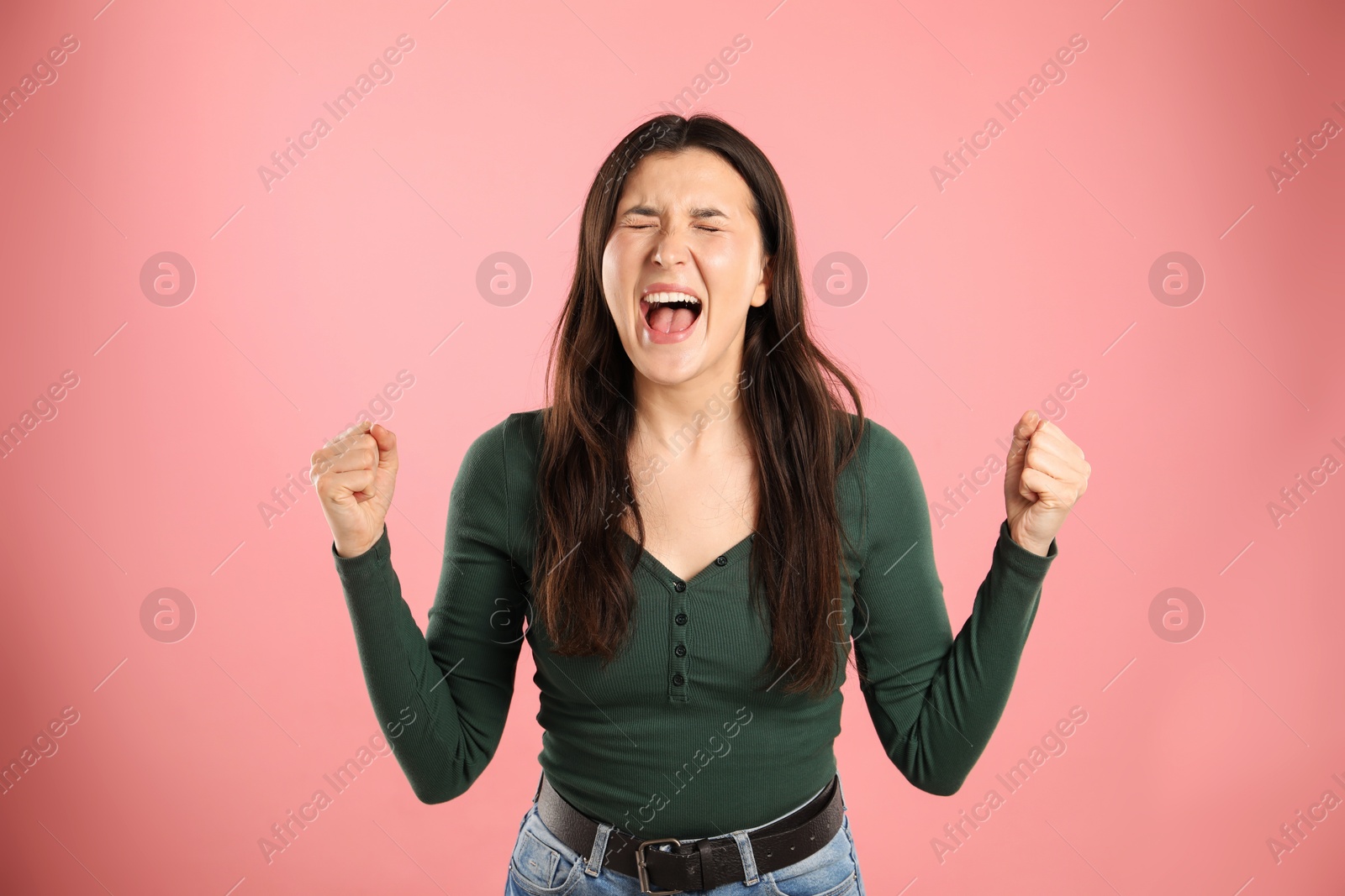 Photo of Portrait of emotional woman on pink background