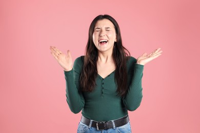 Photo of Portrait of surprised woman on pink background