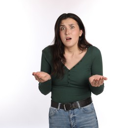 Photo of Portrait of confused woman on white background