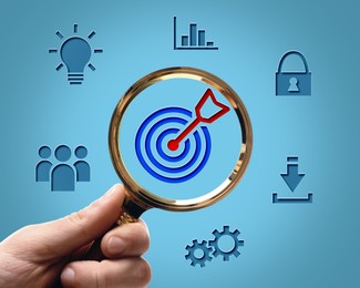 Image of Woman holding magnifying glass with target and arrow inside against blue background, closeup. Different icons around