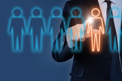 Image of Dismissal. Businessman choosing human figure on virtual screen against blue background, closeup