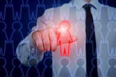 Image of Dismissal. Businessman choosing human figure on virtual screen against dark blue background, closeup