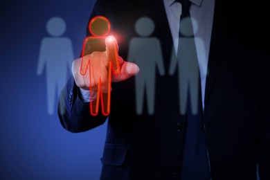 Image of Dismissal. Businessman choosing human figure on virtual screen against dark blue background, closeup