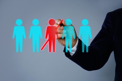 Image of Dismissal. Businessman striking out human figure on virtual screen against grey background, closeup