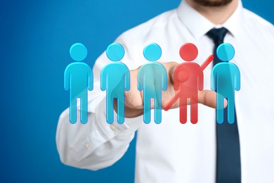 Image of Dismissal. Businessman striking out human figure on virtual screen against blue background, closeup