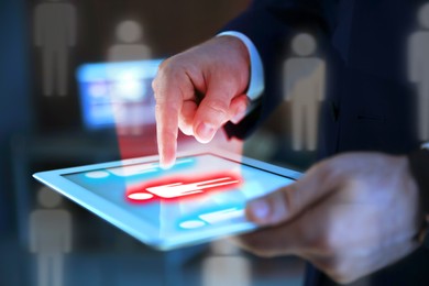 Image of Dismissal. Businessman choosing human figure on tablet computer, closeup