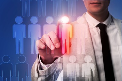 Image of Dismissal. Businessman choosing human figure on virtual screen against dark blue background, closeup