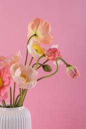 Photo of Beautiful poppy flowers in vase on pink background, closeup