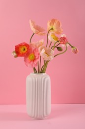 Photo of Beautiful poppy flowers in vase on pink background, closeup