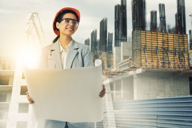 Image of Engineer with draft and unfinished buildings, multiple exposure