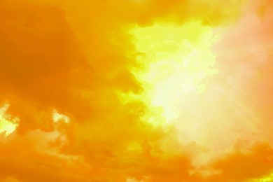 Image of Orange sky with clouds during hot summer weather