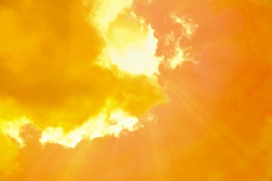 Image of Orange sky with clouds during hot summer weather