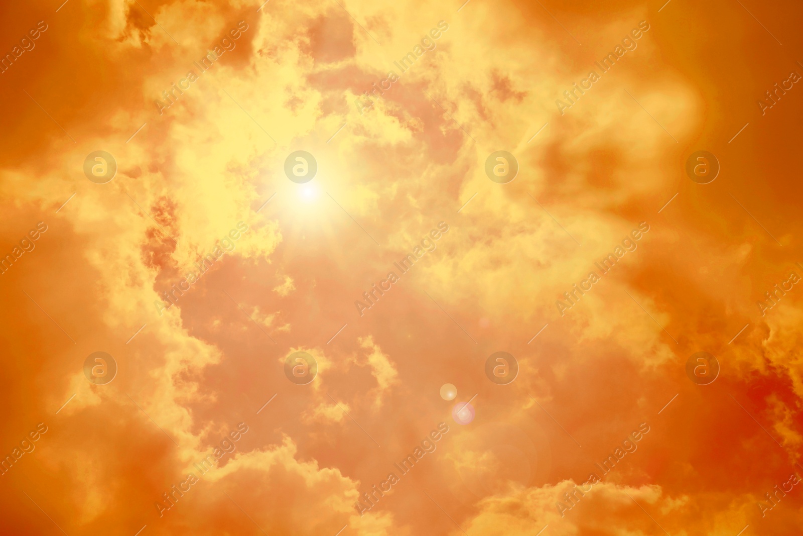 Image of Orange sky with clouds during hot summer weather
