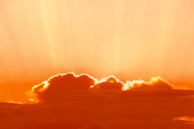 Image of Orange sky with clouds during hot summer weather