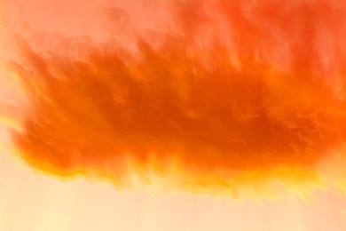Image of Orange sky with clouds during hot summer weather