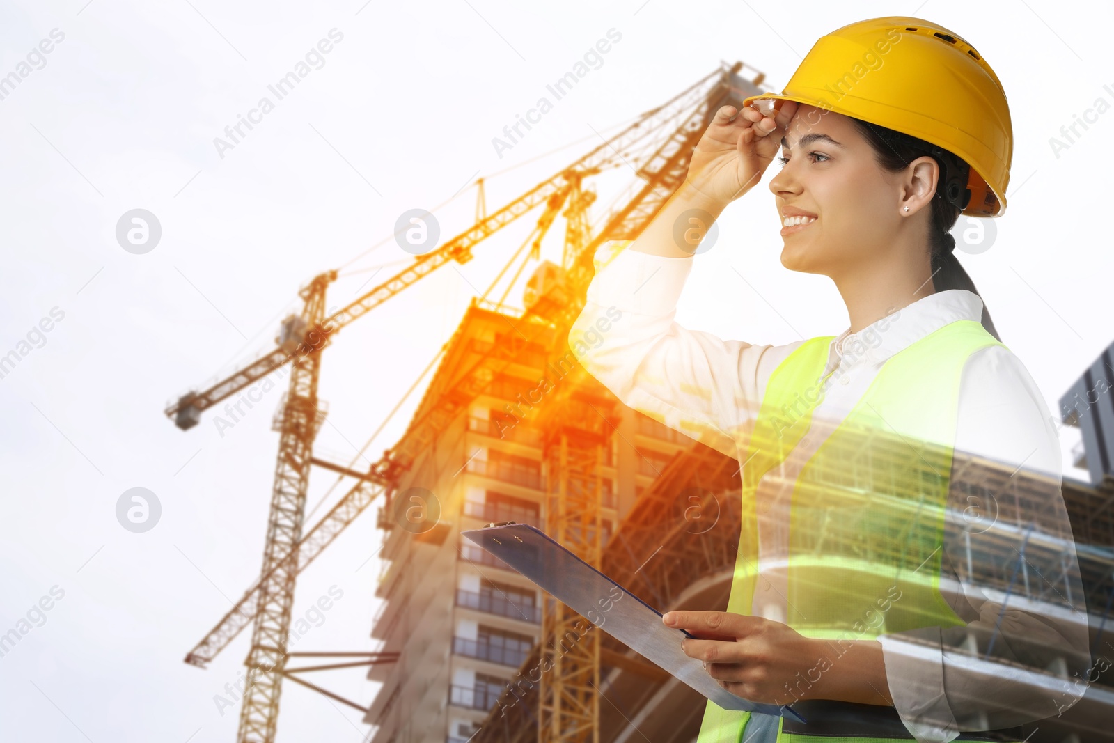 Engineer with clipboard and unfinished building, double exposure Image of Engineer with clipboard and unfinished building, double exposure