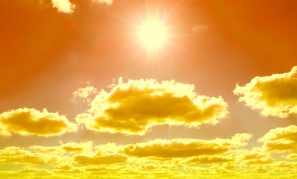 Image of Orange sky with clouds during hot summer weather