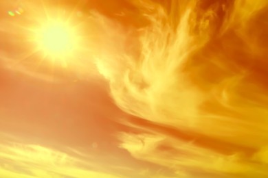Image of Orange sky with clouds during hot summer weather