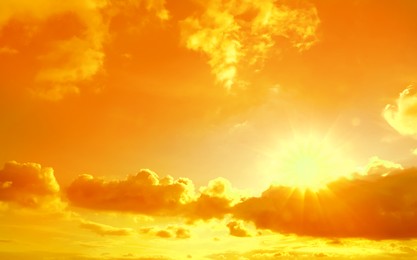 Image of Orange sky with clouds during hot summer weather