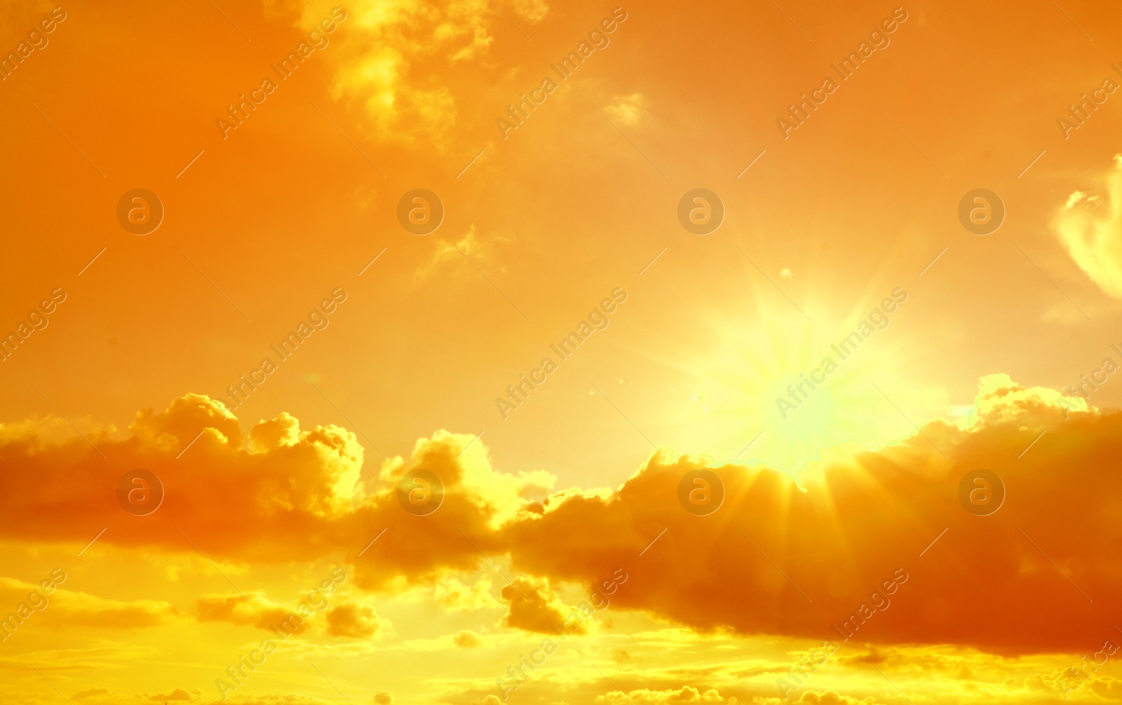 Image of Orange sky with clouds during hot summer weather