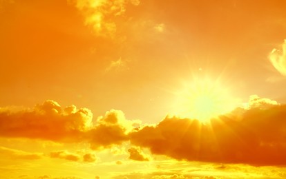 Image of Orange sky with clouds during hot summer weather