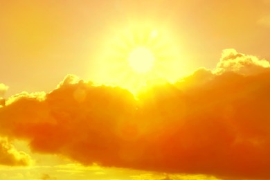 Image of Orange sky with clouds during hot summer weather