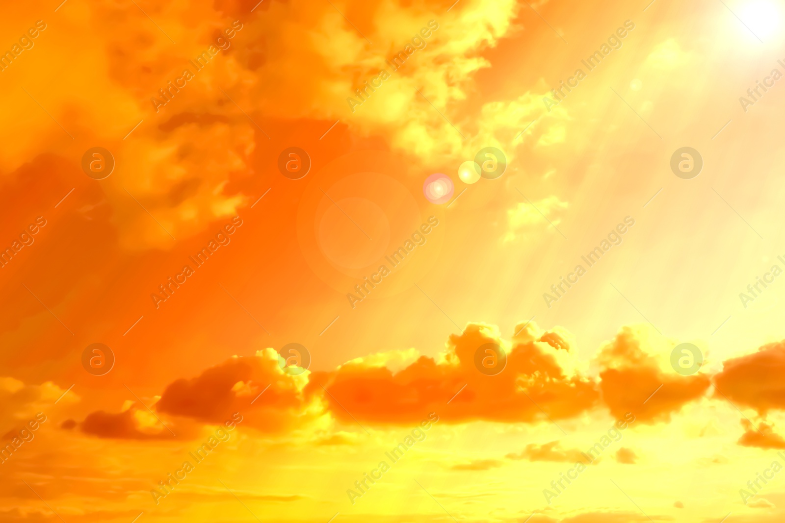 Image of Orange sky with clouds during hot summer weather