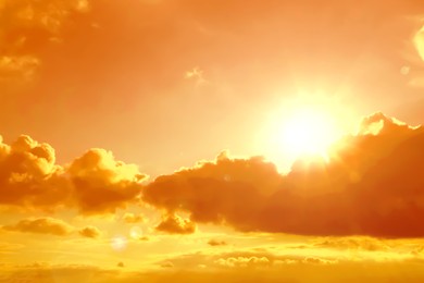 Image of Orange sky with clouds during hot summer weather