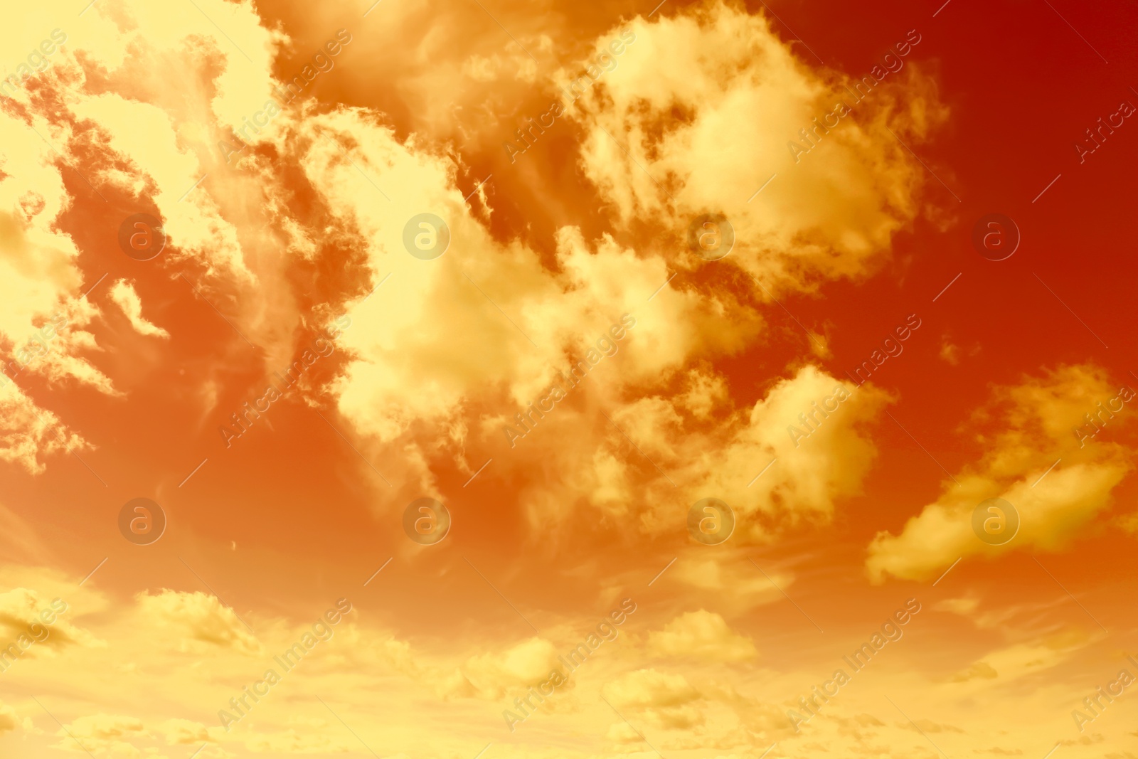 Image of Orange sky with clouds during hot summer weather