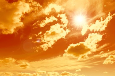 Image of Orange sky with clouds during hot summer weather
