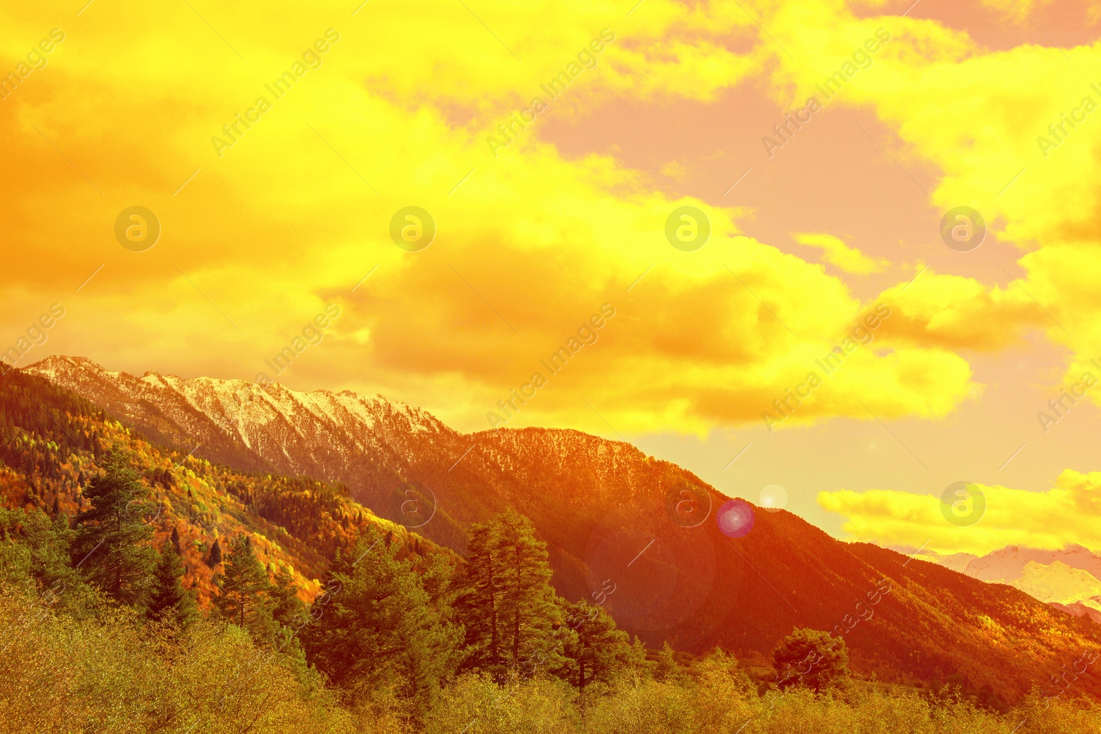 Orange sky with clouds above mountains during hot summer weather Image of Orange sky with clouds above mountains during hot summer weather