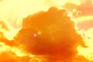 Image of Orange sky with clouds during hot summer weather