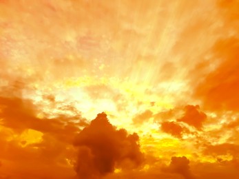 Image of Orange sky with clouds during hot summer weather