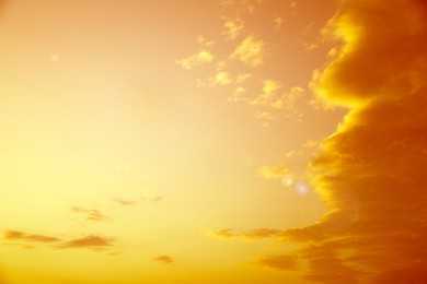Image of Orange sky with clouds during hot summer weather
