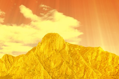 Image of Orange sky with clouds above mountain during hot summer weather