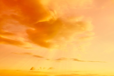 Image of Orange sky with clouds during hot summer weather