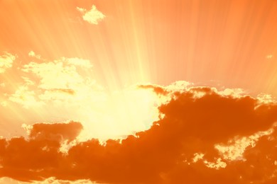 Image of Orange sky with clouds during hot summer weather