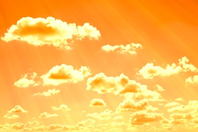 Image of Orange sky with clouds during hot summer weather