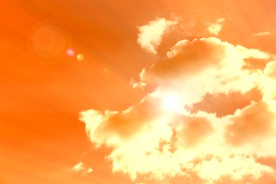 Image of Orange sky with clouds during hot summer weather
