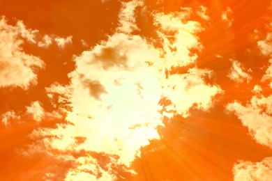 Image of Orange sky with clouds during hot summer weather