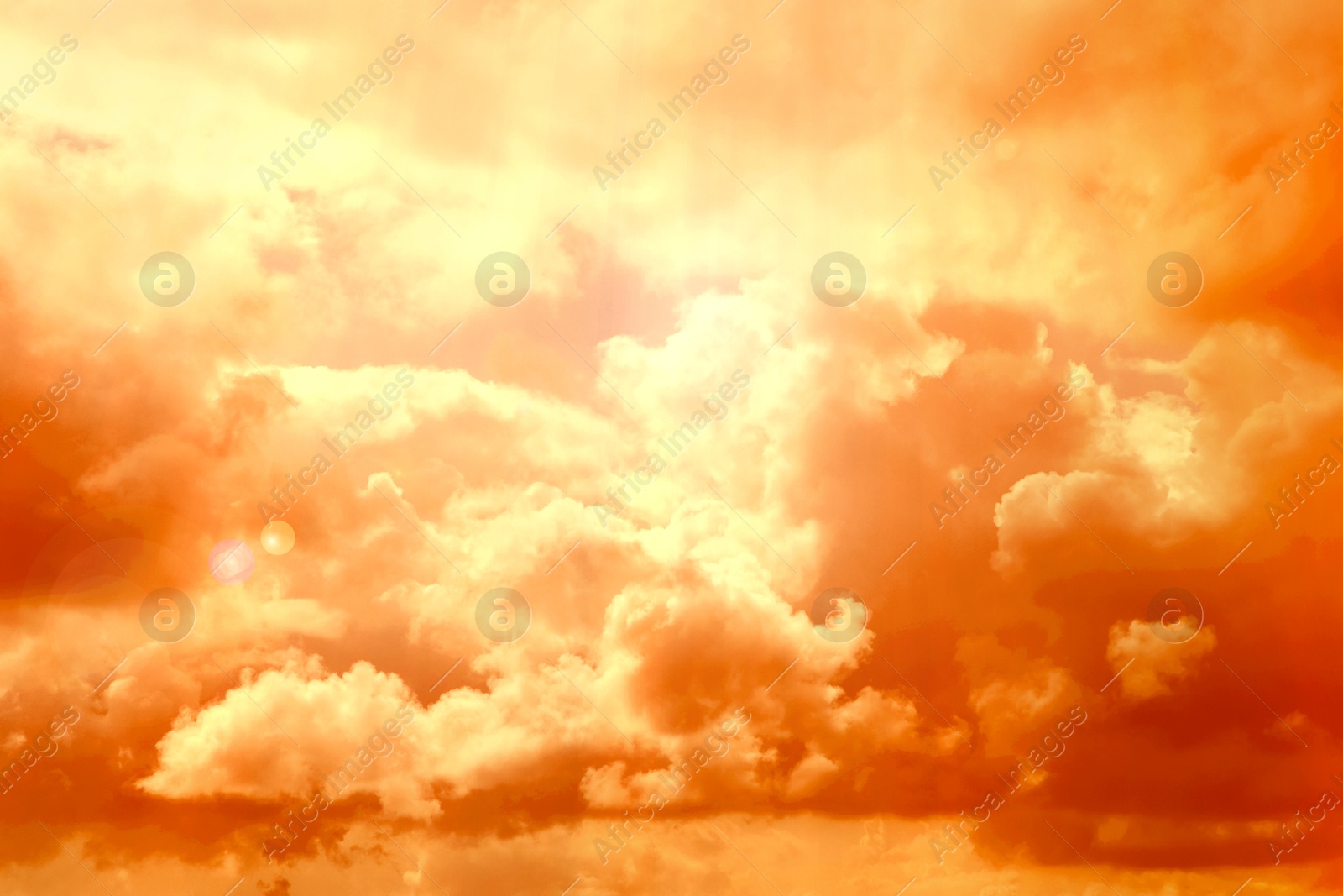 Image of Orange sky with clouds during hot summer weather