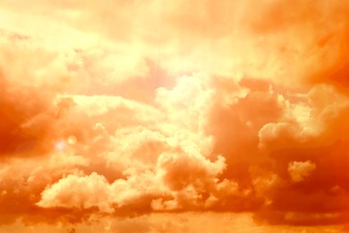Image of Orange sky with clouds during hot summer weather