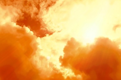 Image of Orange sky with clouds during hot summer weather
