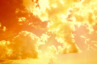 Image of Orange sky with clouds during hot summer weather