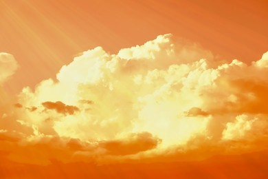 Image of Orange sky with clouds during hot summer weather